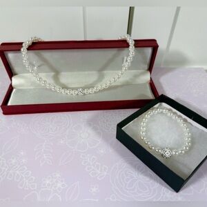 Costume jewelry pearl necklace with matching bracelet.